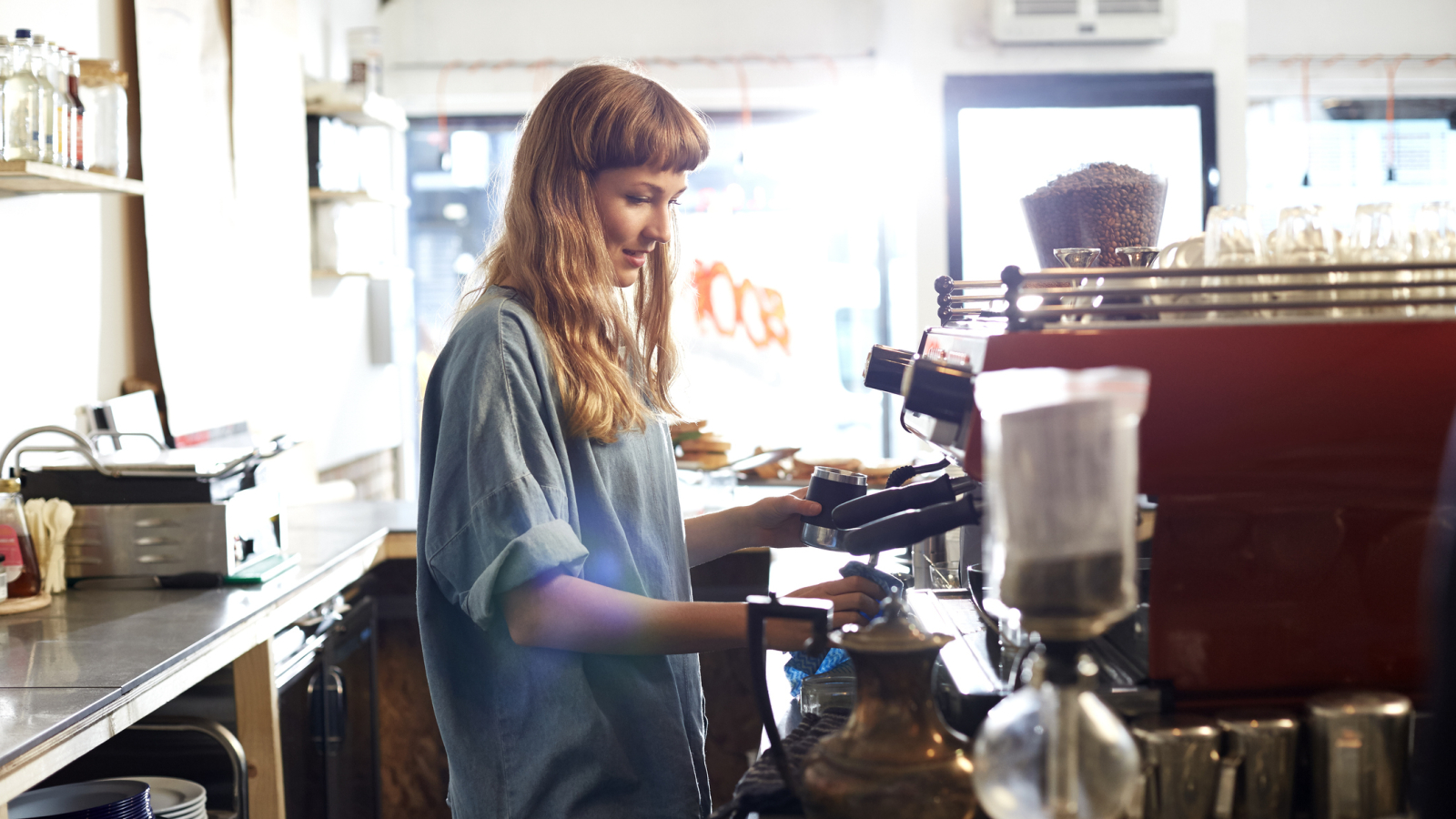 Small business owner works behind cafe counter
