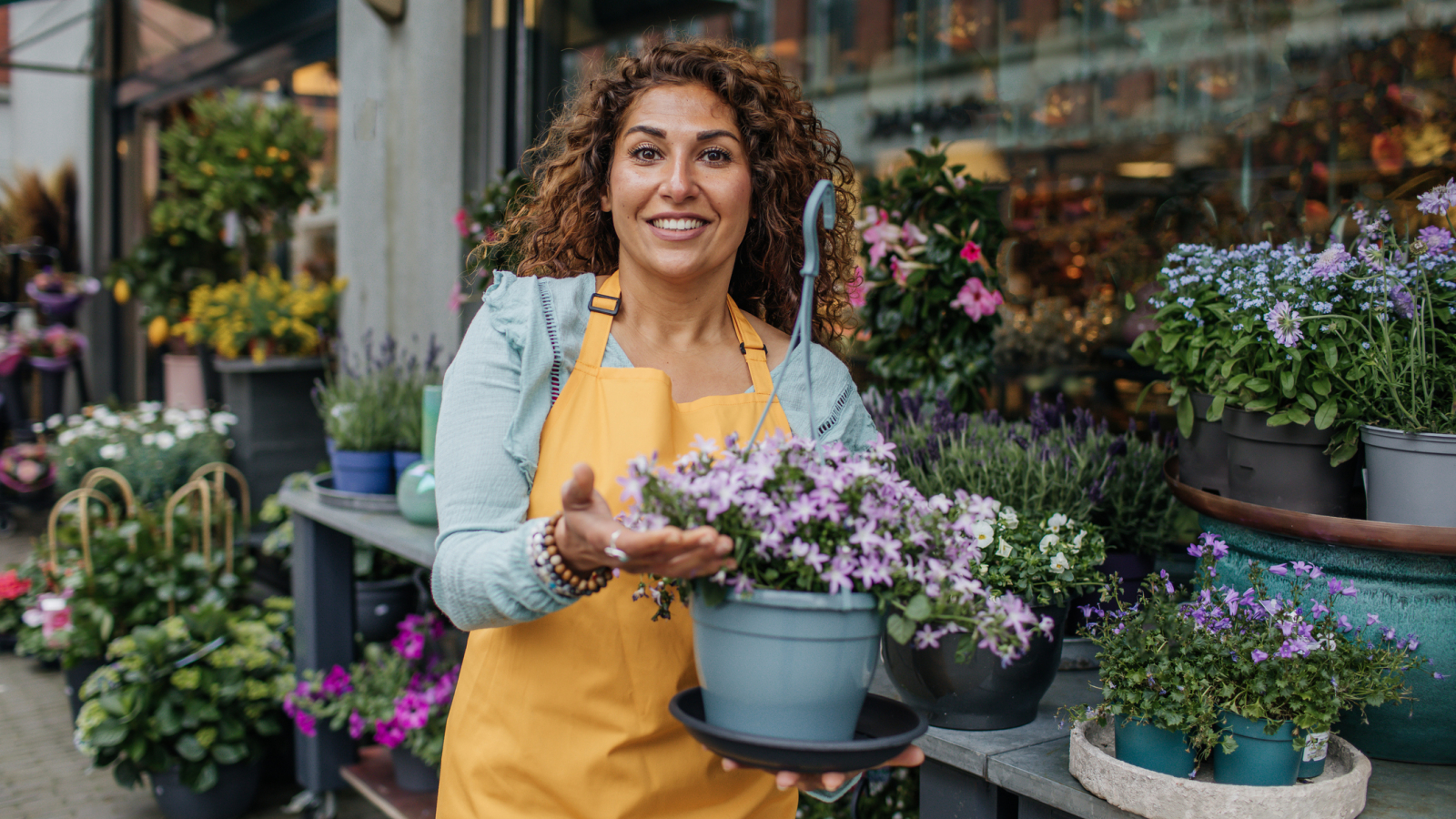 Beautiful diverse female florist working in her flower shop