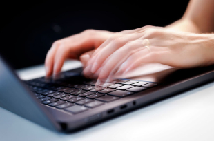 Hands Typing On Laptop