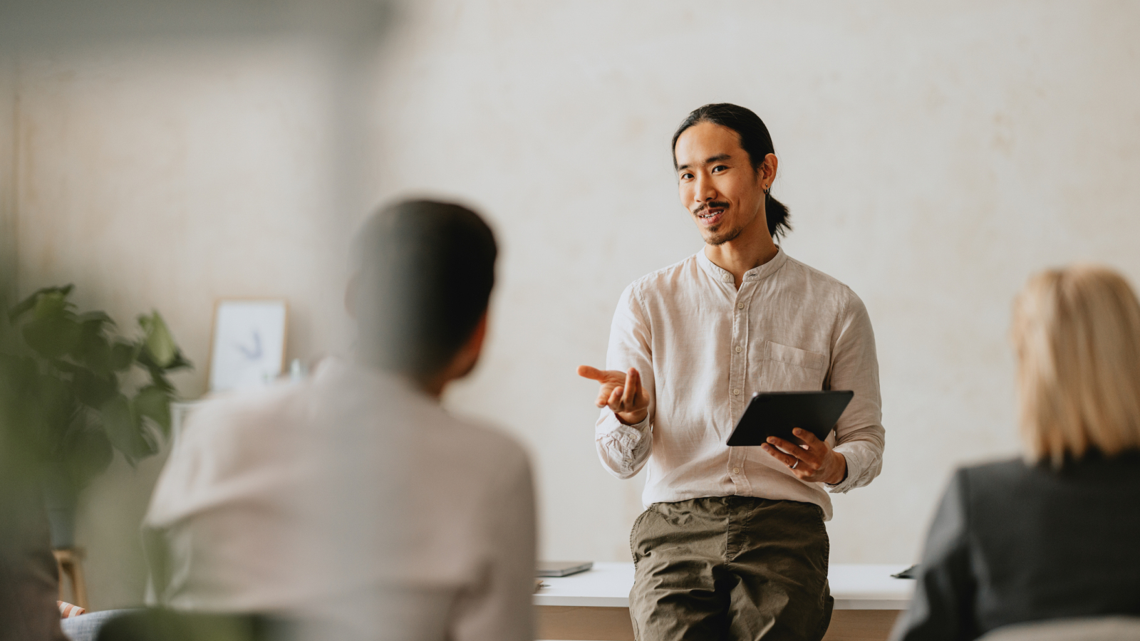 Business Meeting with Presenter in Modern Office Setting