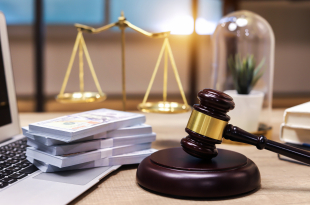 US paper currency on Laptop and gavel,Money with a hammer
