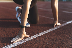 Female athlete on the starting line of a stadium track