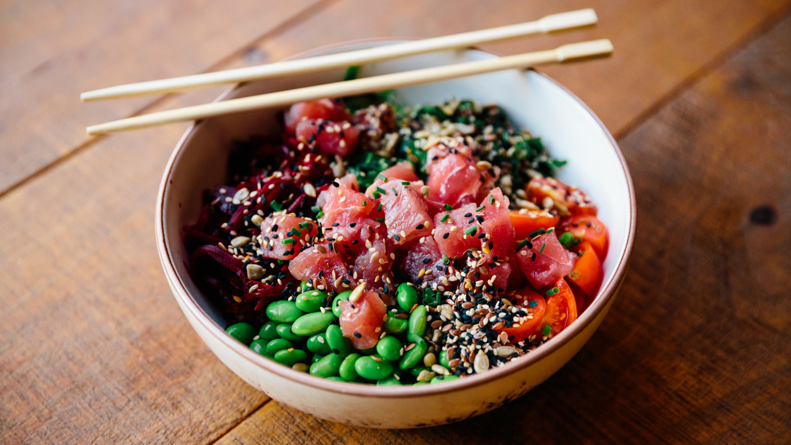 Close-up of poke bowl with tuna, edamame beans and vegetables