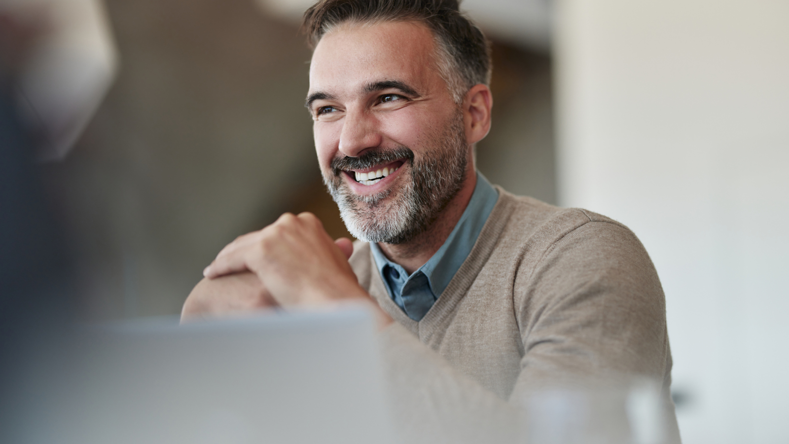 Happy mid adult businessman enjoying in the office.