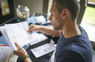 Man preparing his taxes at home