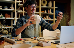 Small business owner Caucasian man guy artist potter salesman blogger influencer mobile phone photo male sculptor craft sale online blog ceramics sell online social media handmade in pottery workshop