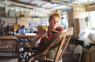 An upholsterer working on a chair