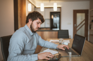 young businessman working at home with laptop
