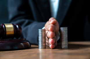 Concept of saving money and investment growth. Lawyer’s hand holding coins on a pile of coins. Division of assets.,Concept of saving and investing.