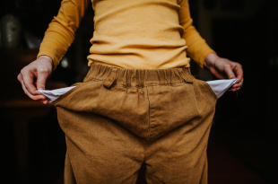 Conceptual image of a child turning their empty pockets inside-out