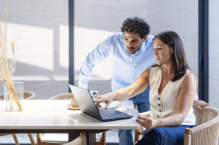 Young couple cooperating while going through their home finances.