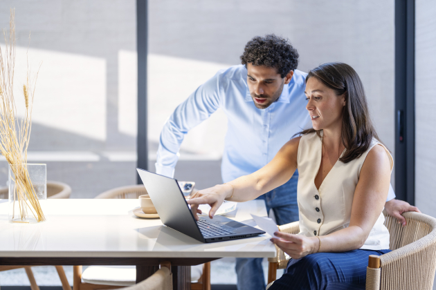 Young couple cooperating while going through their home finances.