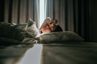 Woman awaking after sleeping well in a nice sleeping room.