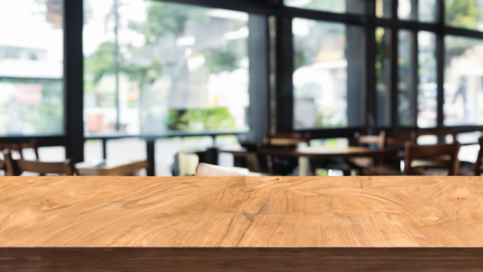 Wooden board empty table in front of blurred background.  Brown wood over blur in coffee shop. Can be used for display or montage your products. Mock up for display of product.