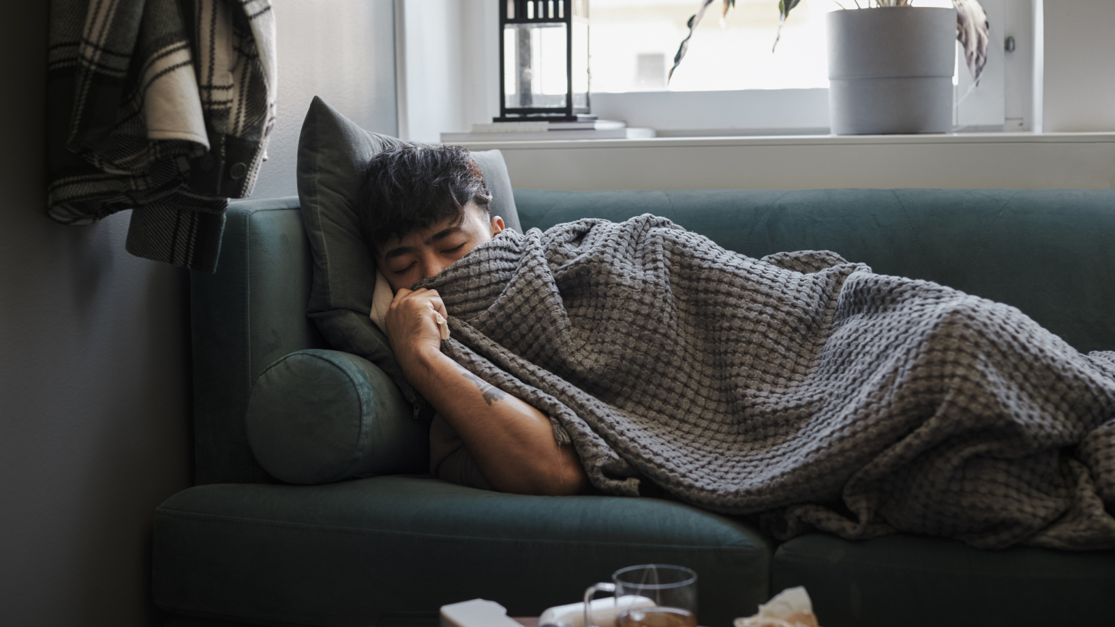 Ill man sleeping on sofa