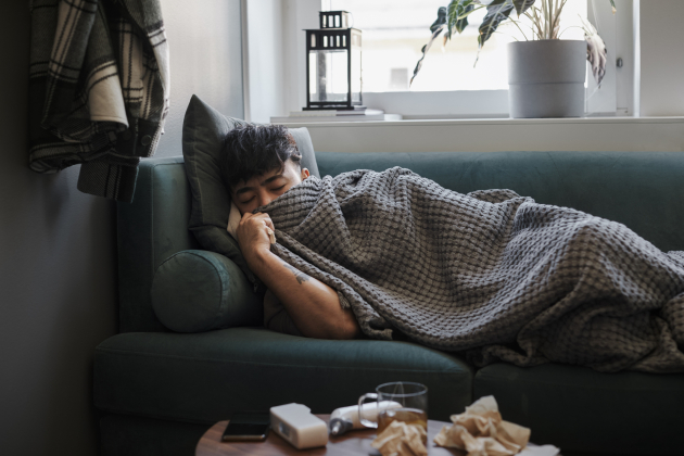 Ill man sleeping on sofa