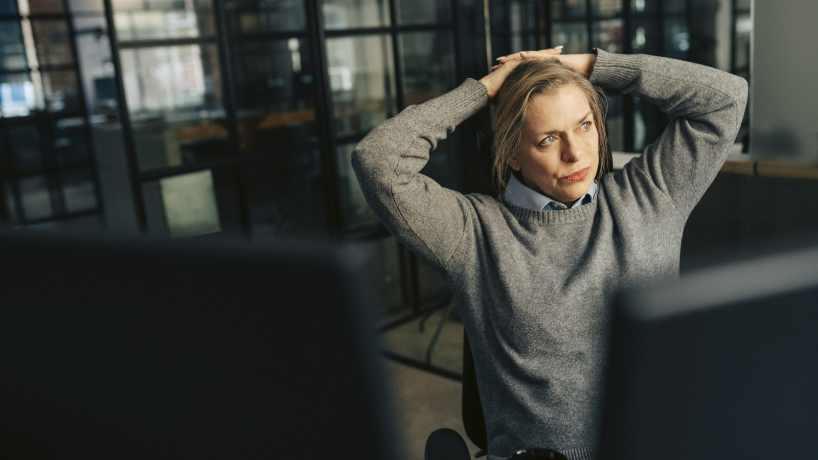 Thoughtful senior businesswoman day dreaming at office