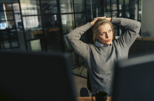 Thoughtful senior businesswoman day dreaming at office