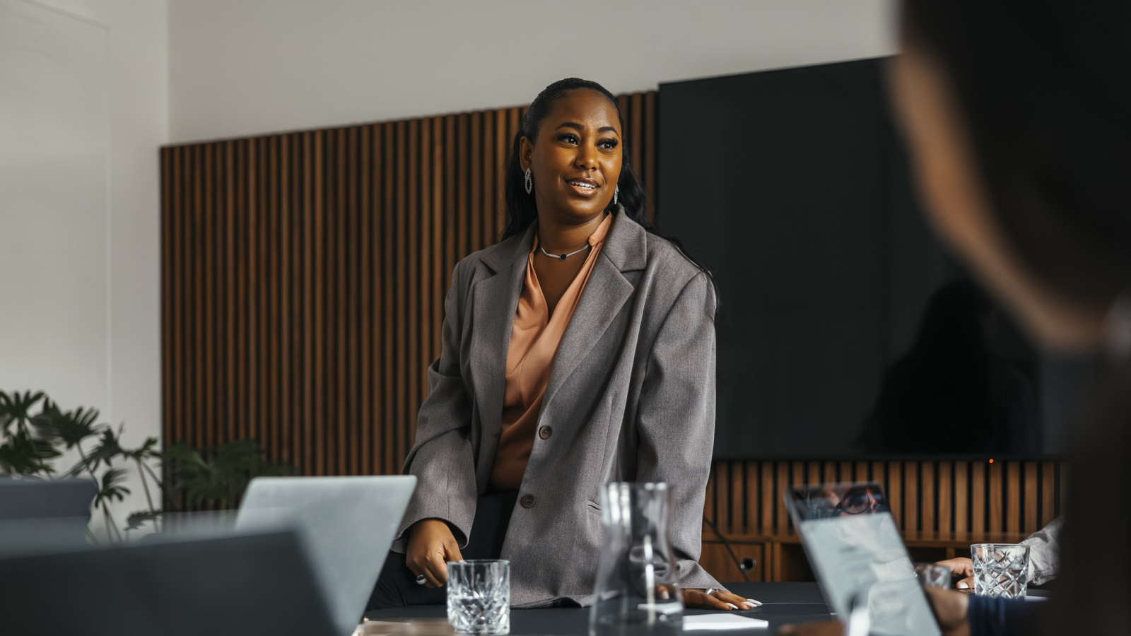 Low angle view of businesswoman communicating with colleagues in office meeting at board room