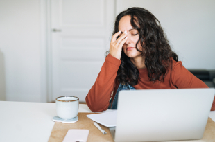 Tired stressed woman working on laptop at home, burnout concept, home office fatigue