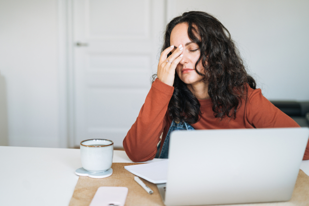 Tired stressed woman working on laptop at home, burnout concept, home office fatigue