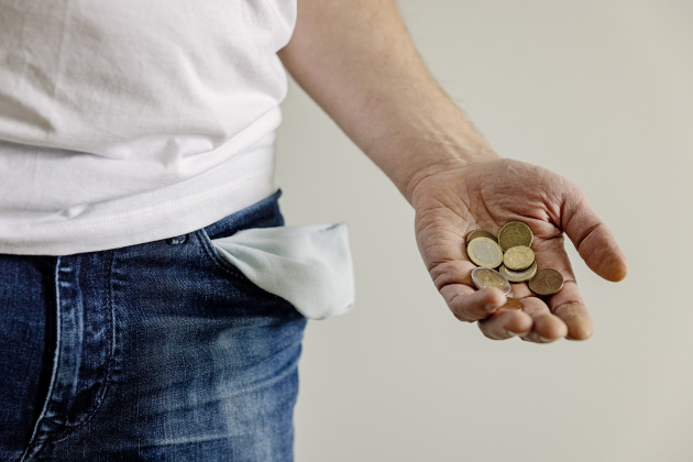 Man holding coins in palm of hand