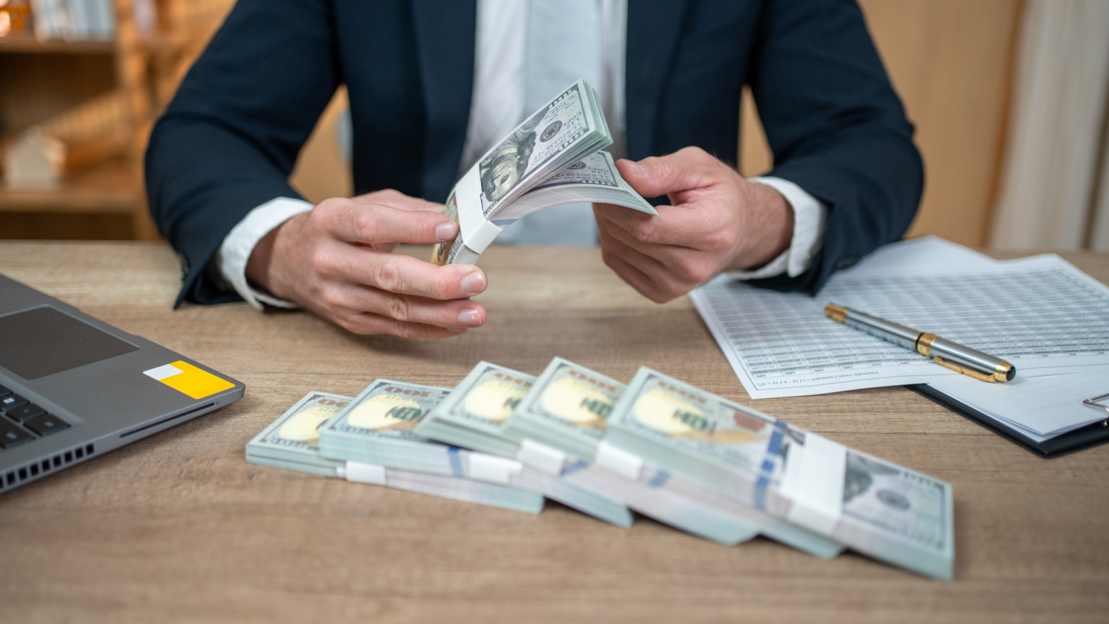 Businessman counting US dollars
