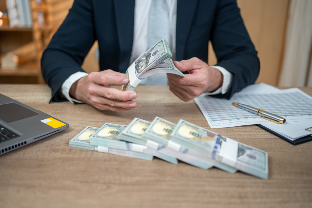 Businessman counting US dollars