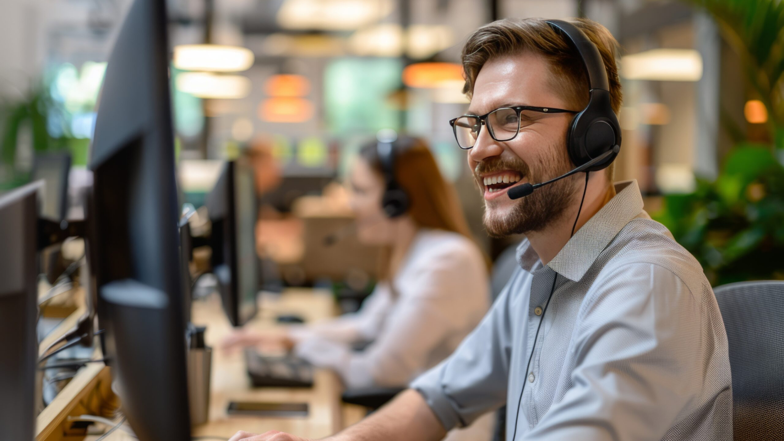 Consulting corporate clients in conversation with customers using computers. Service desk consultant talking in a call center
