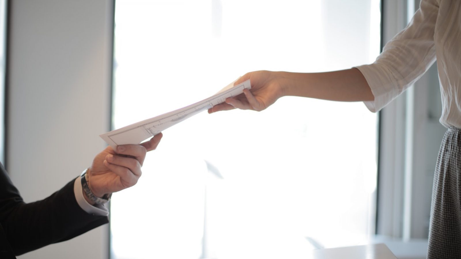 job-applicant-passing-her-documents-3760072